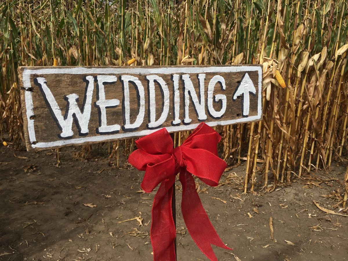 A sign on a dirt road Description automatically generated